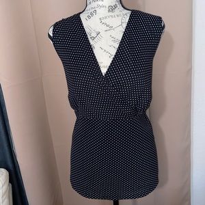 18/20 sleeveless faux wrap design shell. Classic black w/white dot print